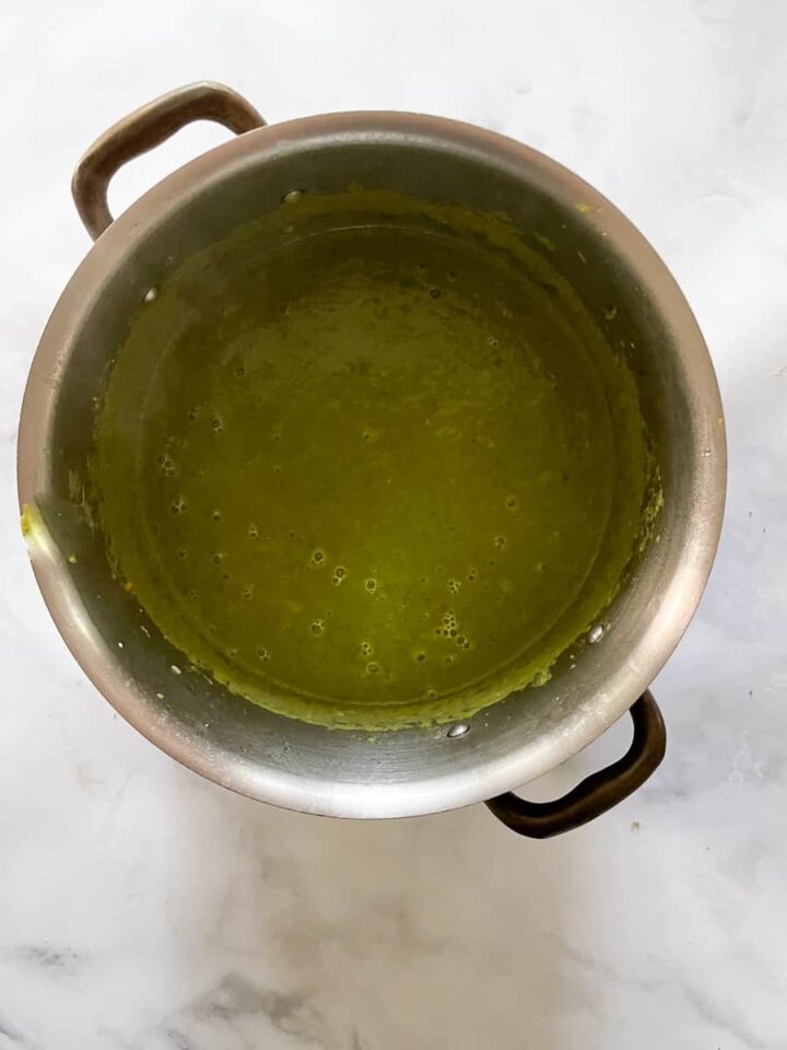 Creamy vegan asparagus soup that's full of fresh vegetable flavors and vibrantly green from plenty of asparagus. Vegan asparagus soup in a pot after being pureed.
