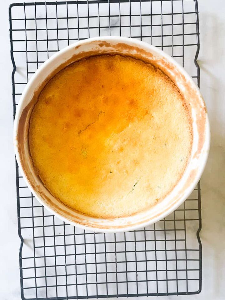 A gluten free souffle cools on a wire rack.