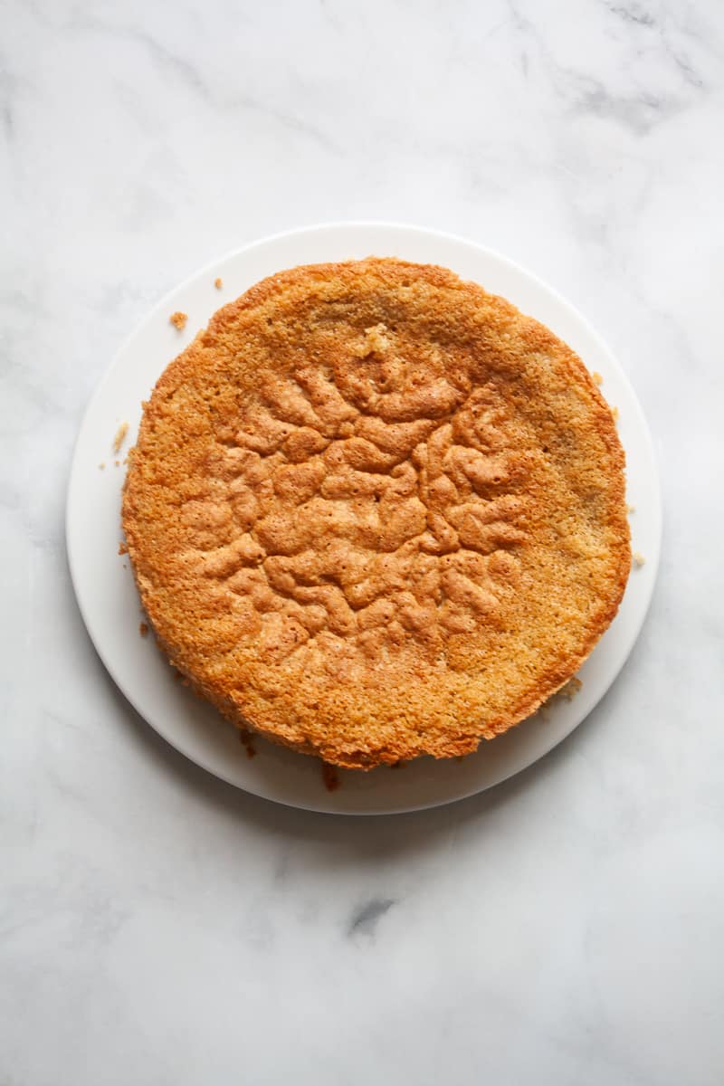 My version of Edna Lewis' Busy Day Cake is a winner - simple ingredients come together to make the most perfectly tender, lightly sweet cake. A gluten free busy day cake on a white background.