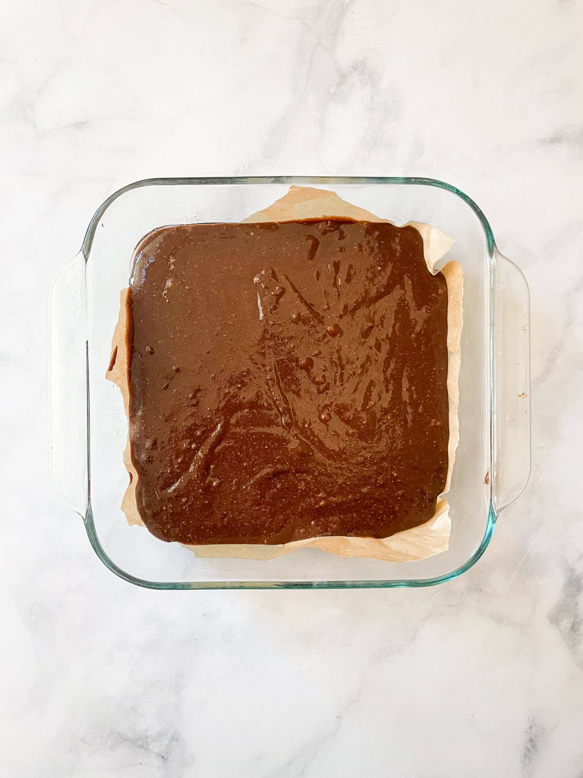 Rich whole wheat brownies are just like your favorite brownie recipe but made with whole wheat flour and melted chocolate. Brownie batter in a baking dish.