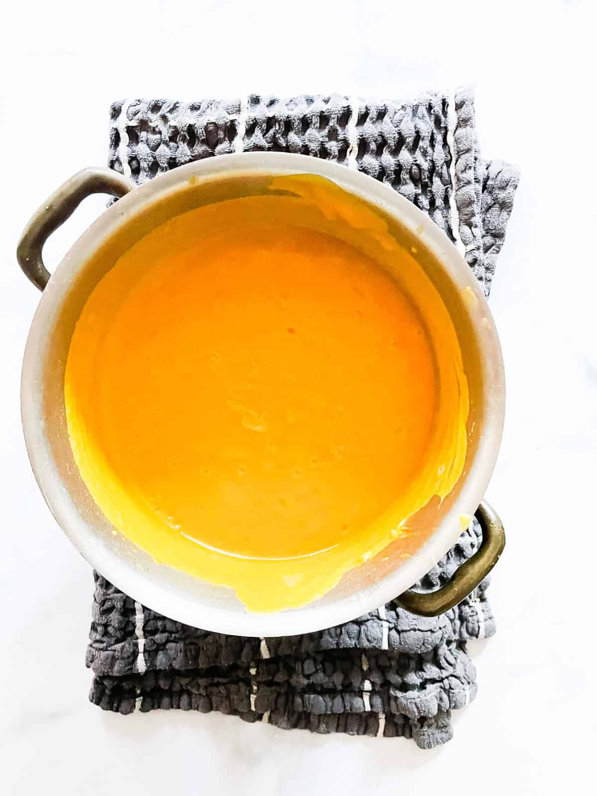 This gluten free butternut squash soup recipe elevates a classic with coconut milk, fresh ginger, and soy sauce. A soup pot full of pureed butternut squash soup.