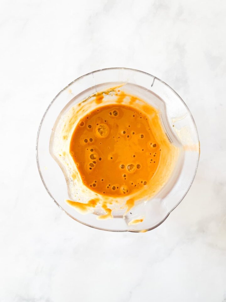 Silky smooth ginger peanut sauce features fresh ginger swirled with lots of peanut butter, a little garlic, tamari sauce, and sesame sauce. Pureed peanut sauce in a blender.