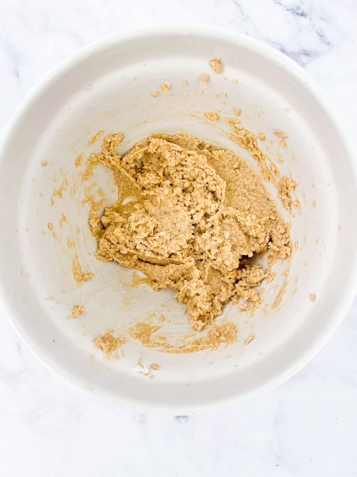 These whole wheat flour chocolate chip cookies will quickly replace your old favorite chocolate chip cookie recipe. They are THE BEST. Eggs are added to cookie dough in a bowl.