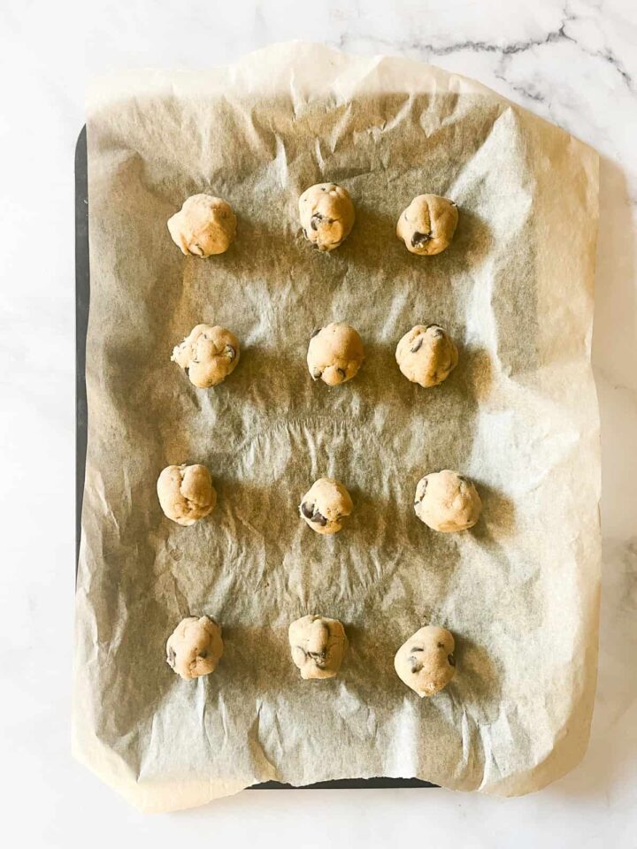 These whole wheat flour chocolate chip cookies will quickly replace your old favorite chocolate chip cookie recipe. They are THE BEST. Cookie dough balls on a baking sheet.