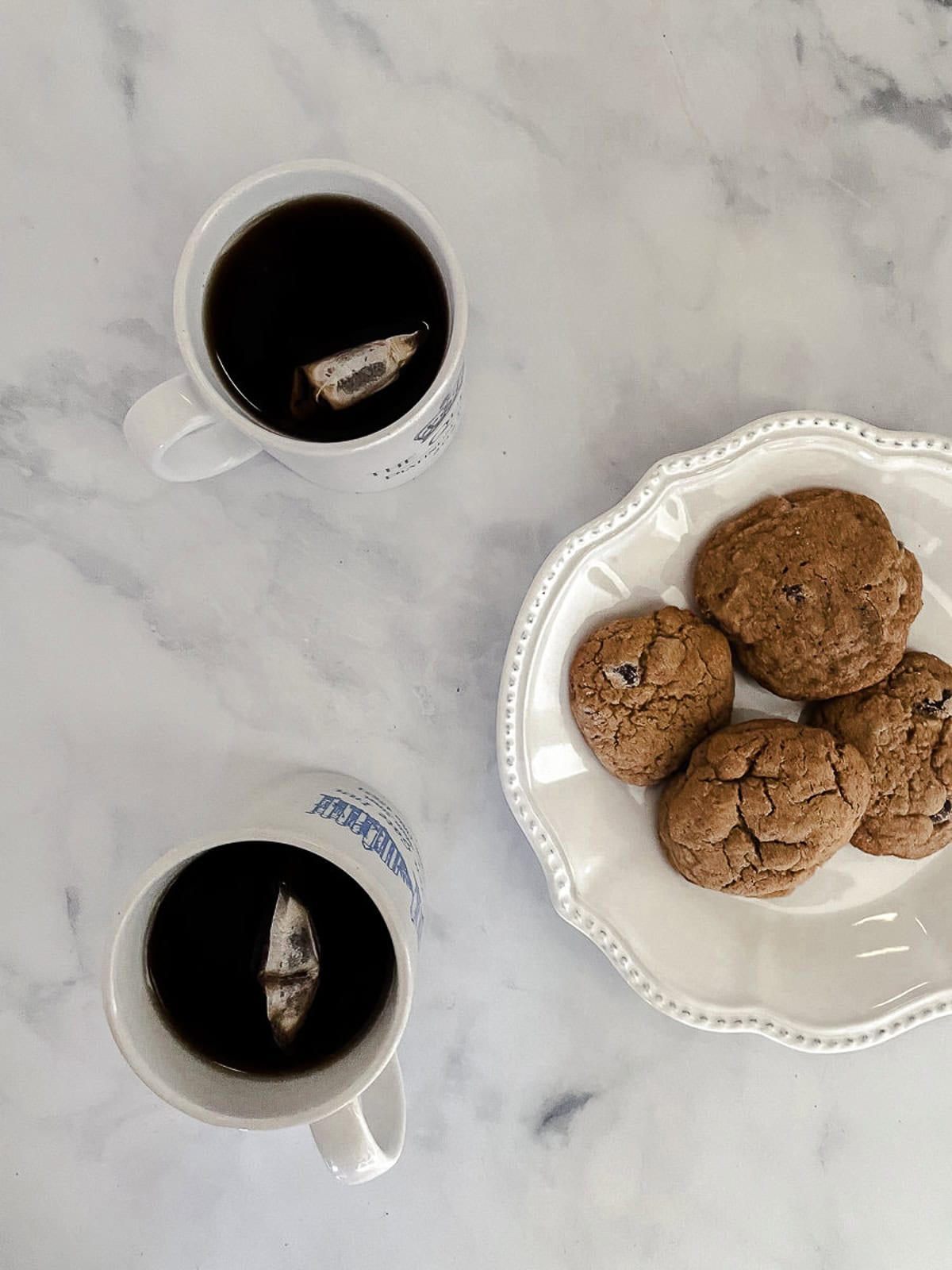 These whole wheat flour chocolate chip cookies will quickly replace your old favorite chocolate chip cookie recipe. They are THE BEST. A plate of whole wheat chocolate chips cookies and two cups of tea.