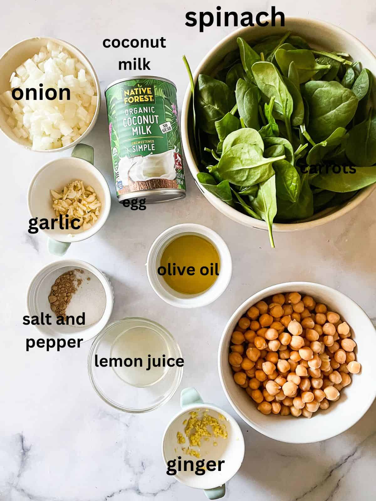 Easy curried chickpeas with coconut and spinach are spiked with fresh lemon juice. Serve over brown rice or quinoa for a gluten-free dinner. Ingredients for curried chickpeas with coconut milk are text-labeled.