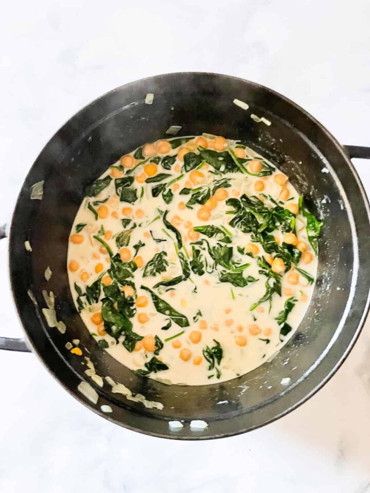 Easy curried chickpeas with coconut and spinach are spiked with fresh lemon juice. Serve over brown rice or quinoa for a gluten-free dinner.