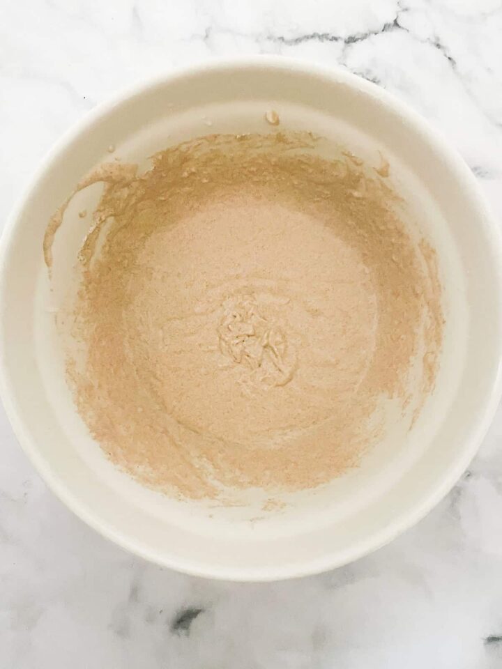 Fluffy whole wheat waffles made with whole grain flour, Greek yogurt, and melted butter! Perfect for a lazy weekend morning. Waffle mix in a bowl.