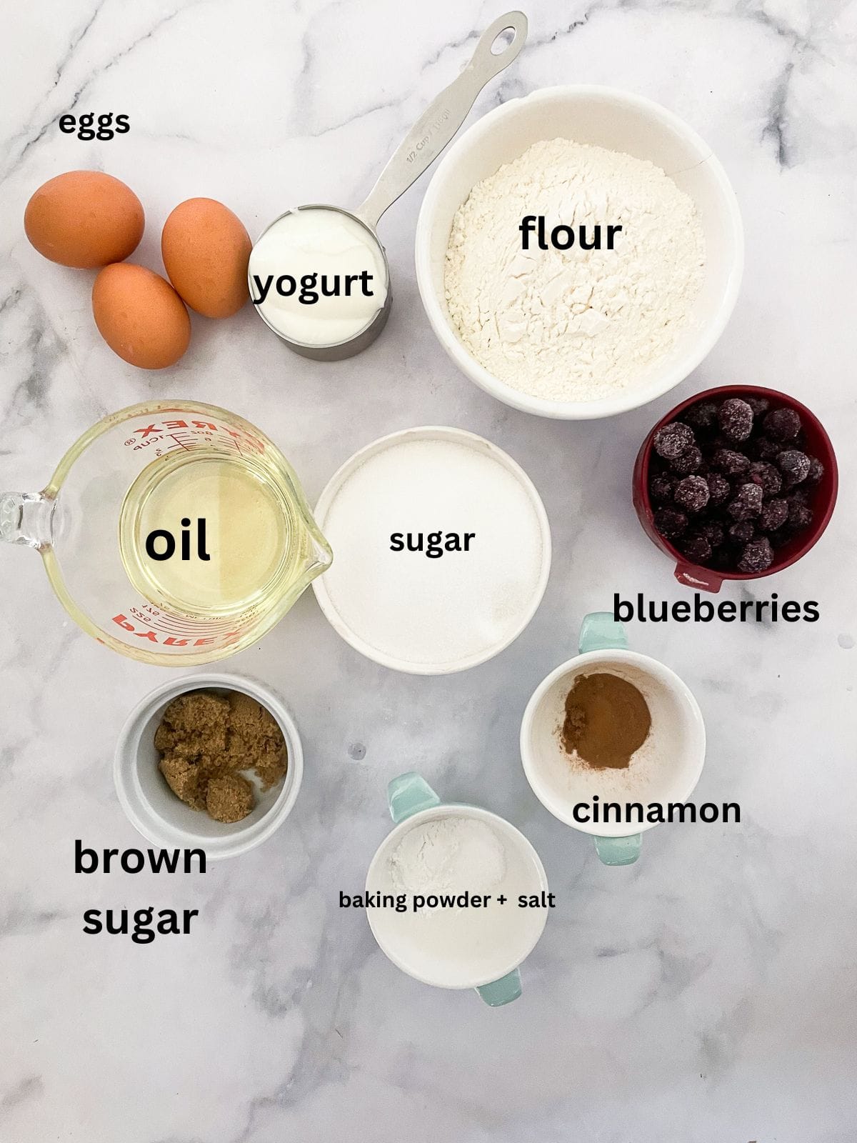 This luscious blueberry yogurt cake is loaded with juicy berries and a sweet cinnamon swirl. Gluten-free option included! Ingredients for blueberry yogurt cake are text-labeled.