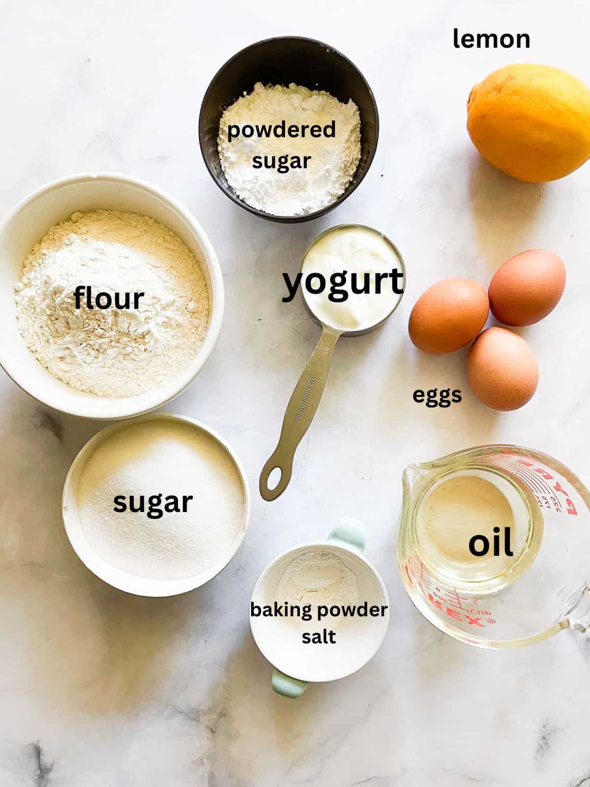 This classic French-inspired lemon yogurt cake is a reliable one-bowl recipe that always turns out perfectly. Ingredients for lemon yogurt cake are text labeled.