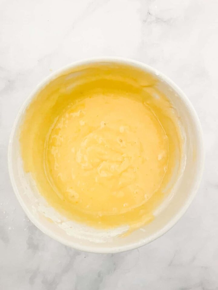 This luscious blueberry yogurt cake is loaded with juicy berries and a sweet cinnamon swirl. Gluten-free option included! Blueberry yogurt cake batter in a bowl.