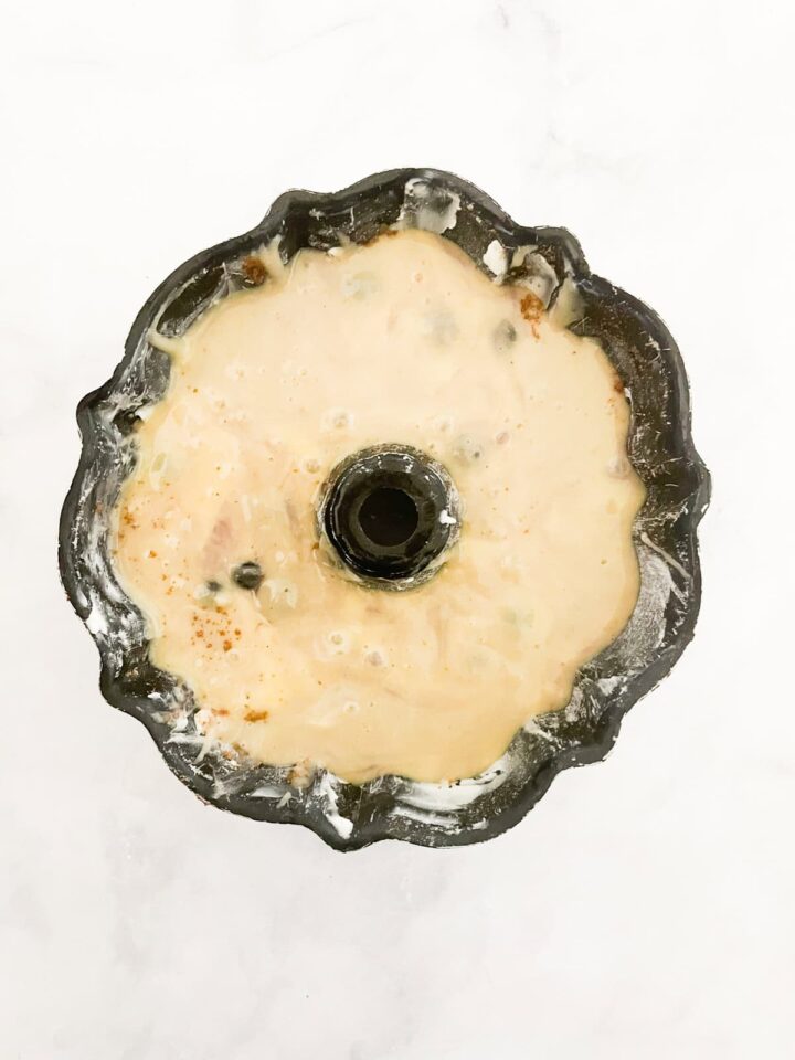 This luscious blueberry yogurt cake is loaded with juicy berries and a sweet cinnamon swirl. Gluten-free option included! Blueberry yogurt cake batter in a bundt pan.