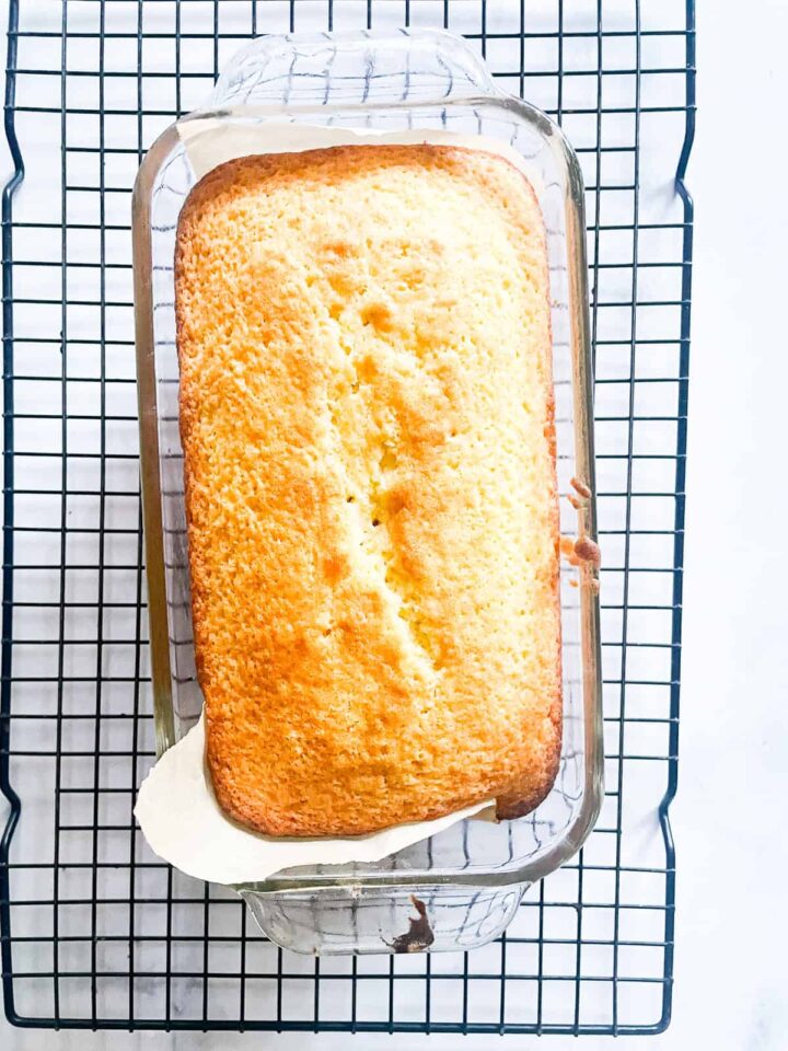 This classic French-inspired lemon yogurt cake is a reliable one-bowl recipe that always turns out perfectly. A loaf of lemon yogurt cake cools on a rack.