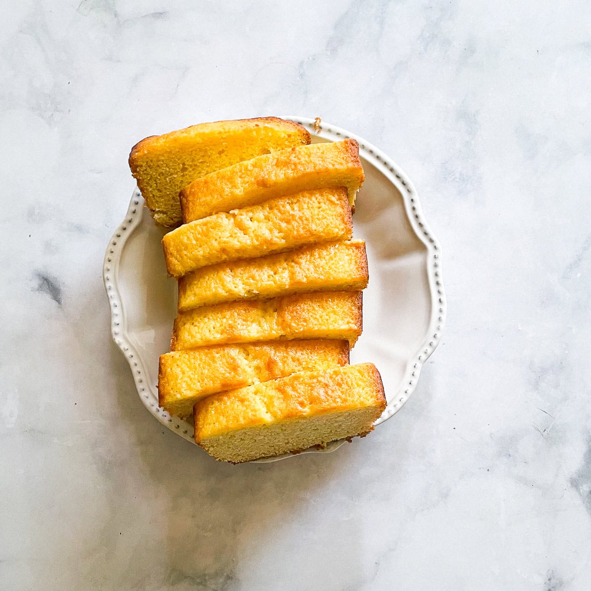 Slices of lemon yogurt cake on a plate.