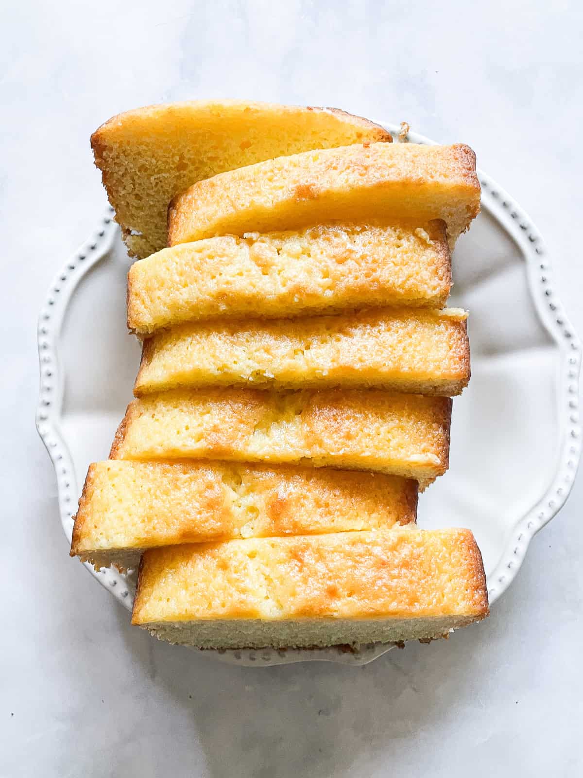 Slices of lemon yogurt cake on a plate.