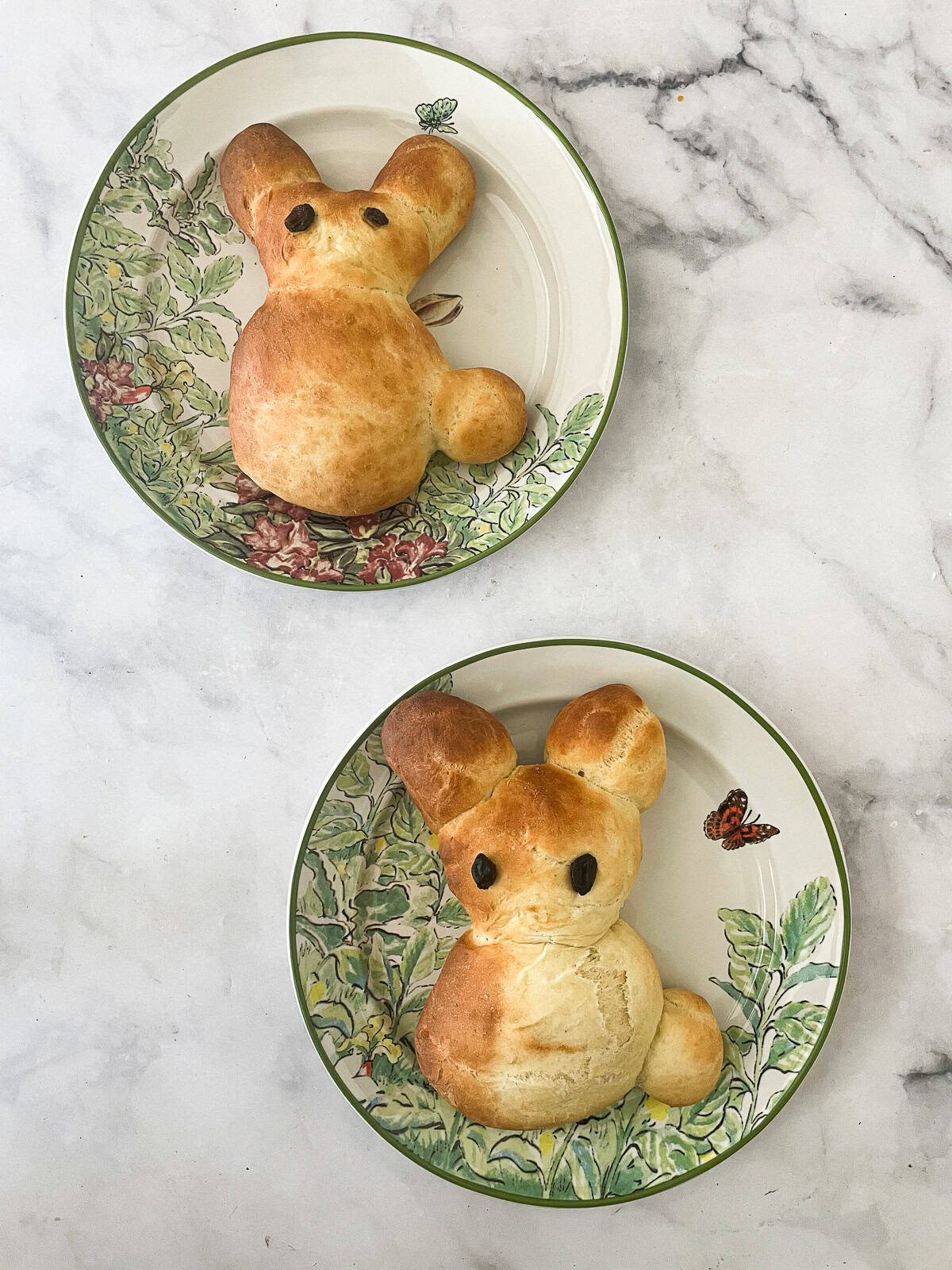Kids love bunny bread that stars an easy, yeast-based dough that's simple to mix, fun to knead, and bakes up into the cutest golden bunnies. Two bunny breads on plates