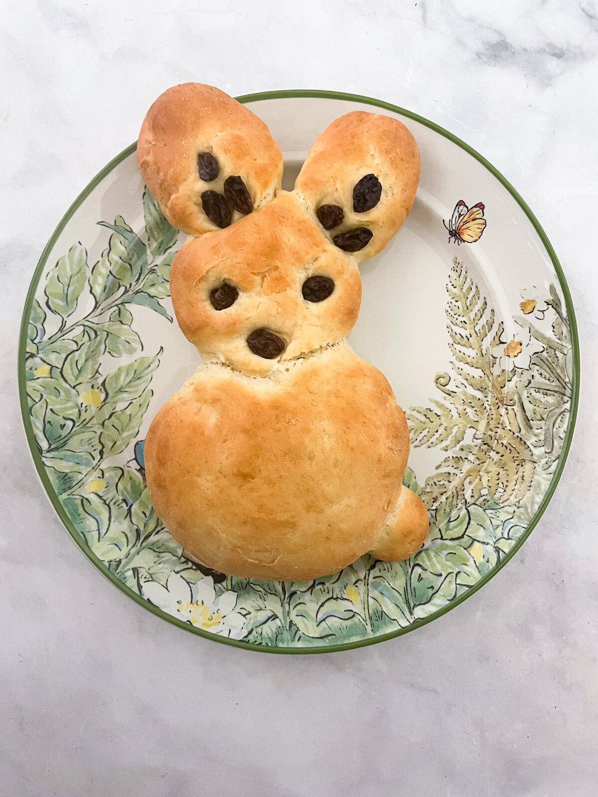 A bunny shaped bread on a plate.