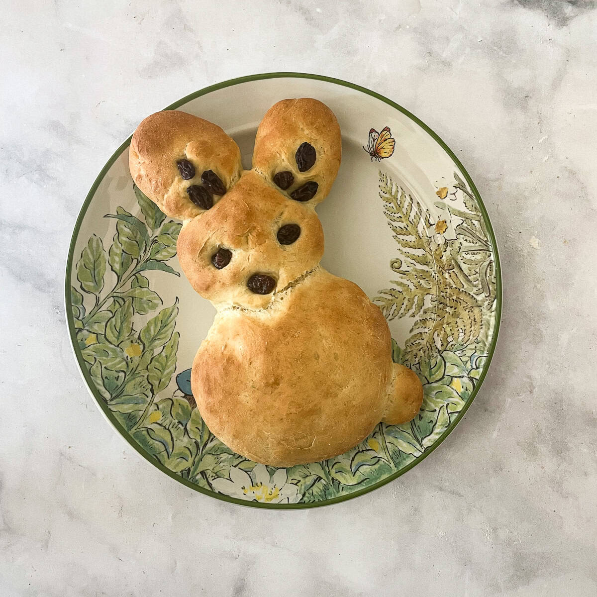 A cute bunny bread decorated with raisins.