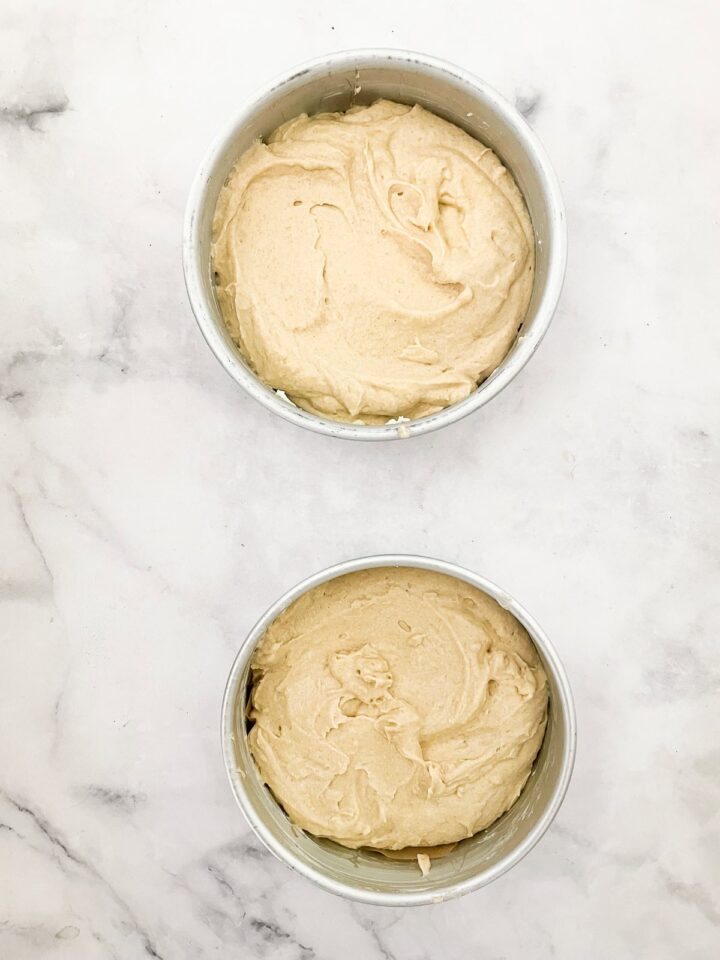 This beautifully simple and versatile buttermilk cake goes well with all sorts of frostings and can be used to make layer cakes and cupcakes. Buttermilk cake batter added to cake pans.