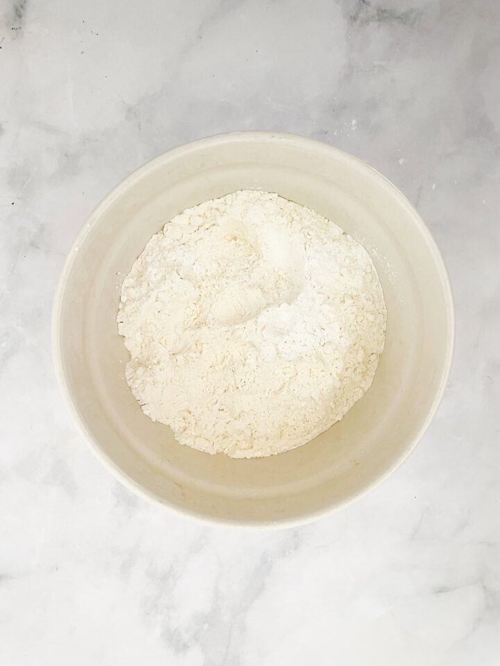 This beautifully simple and versatile buttermilk cake goes well with all sorts of frostings and can be used to make layer cakes and cupcakes. Dry mix for buttermilk cake in a bowl.