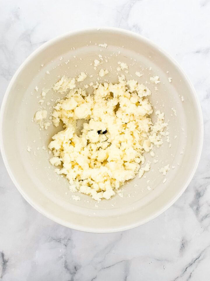 This beautifully simple and versatile buttermilk cake goes well with all sorts of frostings and can be used to make layer cakes and cupcakes. Butter and sugar creamed in a bowl.