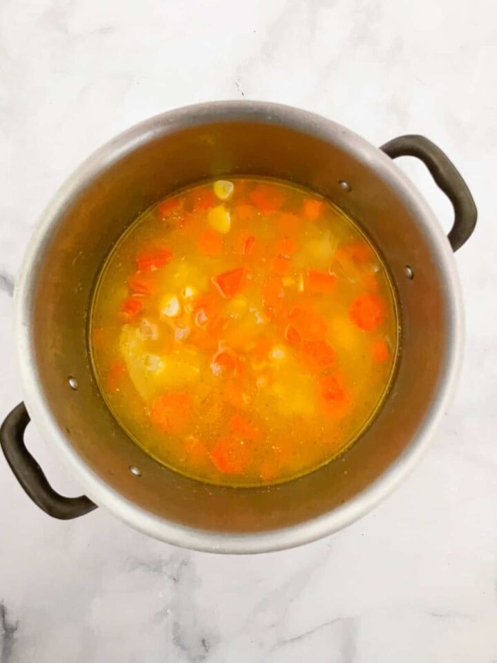 Creamy carrot & coconut soup made with simple ingredients. Naturally vegan, gluten-free, and perfect for weeknight dinners or meal prep. Water is added to sauteed carrots.