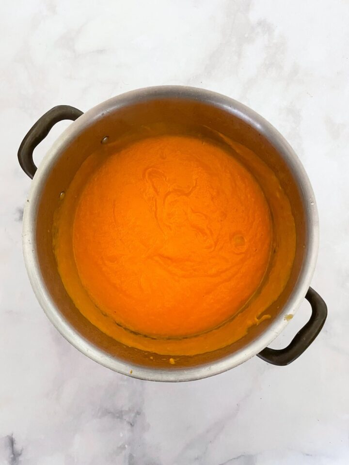 Creamy carrot & coconut soup made with simple ingredients. Naturally vegan, gluten-free, and perfect for weeknight dinners or meal prep. Carrot soup is pureed in a pot.