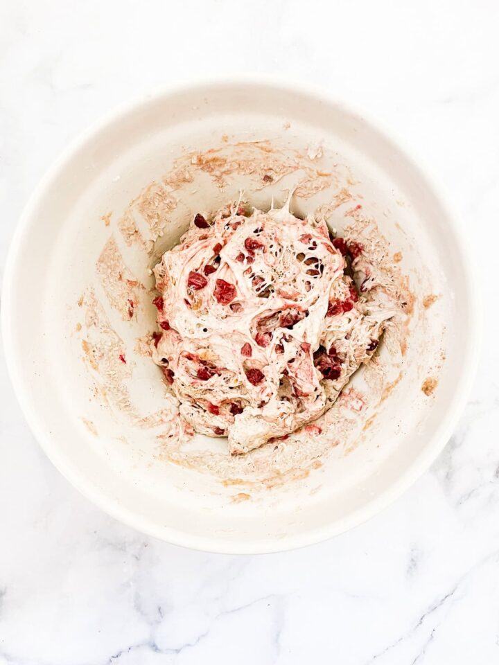 No-knead cranberry walnut bread is studded with sweet-tart dried fruit and crunchy nuts. An easy homemade version of a bakery loaf. Dough after being deflated.
