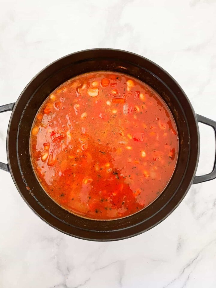 Water is added to a pot of chili.