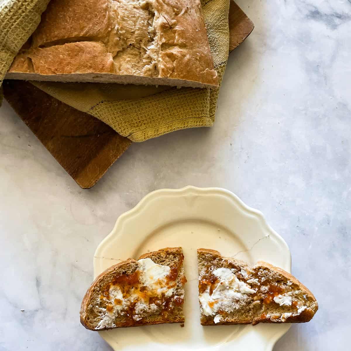 A loaf of porridge bread with a slice of bread.