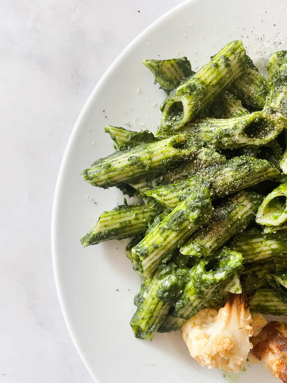 This easy, vegetarian kale pasta sauce is made from garlic sizzled in olive oil, bright green kale, and a bit of lemon zest for extra flavor. Ziti with kale pasta sauce.