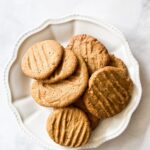 A white plate of oat flour peanut butter cookies.