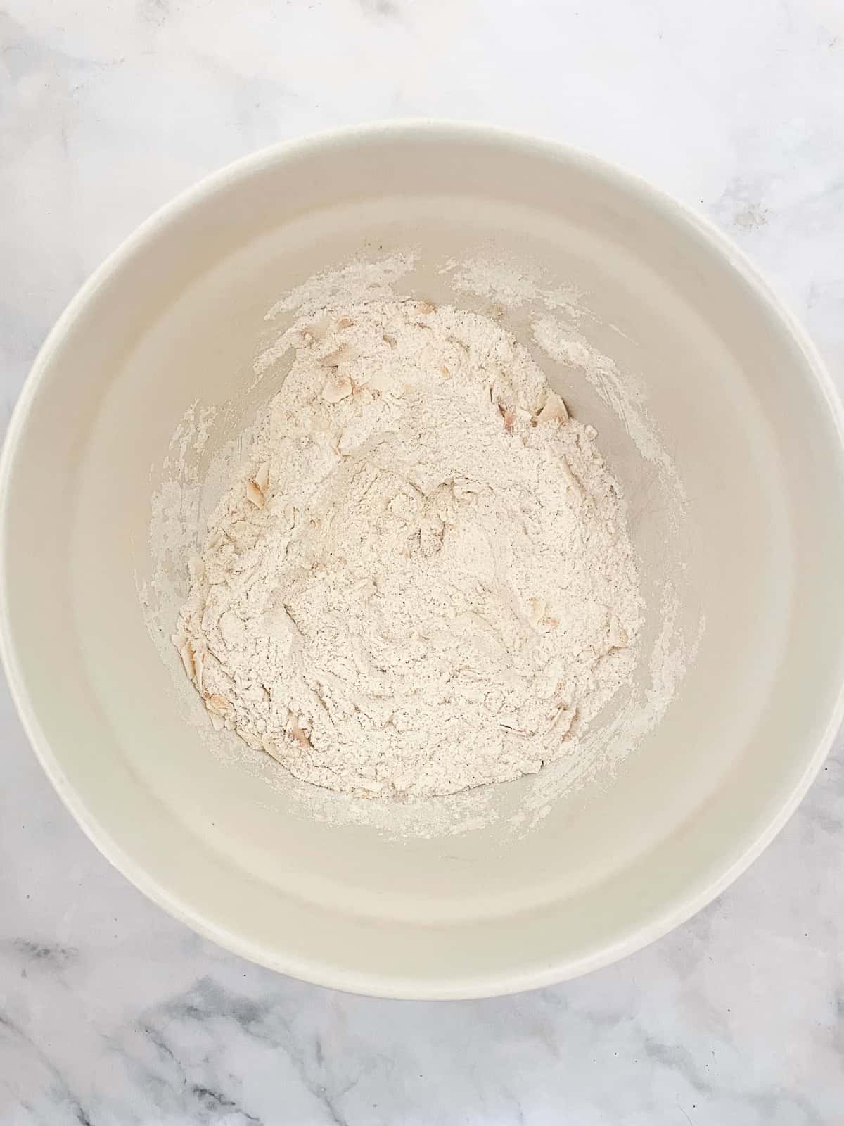 A cinnamon-kissed coconut loaf cake packed with bits of flaked coconut. Inspired by the classic Bill Granger recipe from "Australian Food." Flaked coconut is added to the flour mix for coconut loaf bread.
