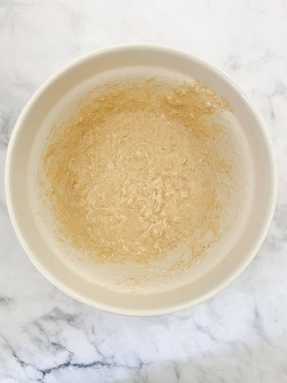 A cinnamon-kissed coconut loaf cake packed with bits of flaked coconut. Inspired by the classic Bill Granger recipe from "Australian Food." The batter for coconut loaf cake in a bowl.