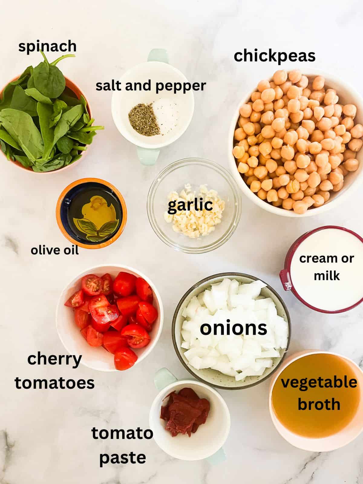 Marry me chickpeas is a vegetarian twist on a popular dish, featuring tender chickpeas and spinach in a tomato broth plus a splash of cream. Ingredients for marry me chickpeas are portioned and labeled.