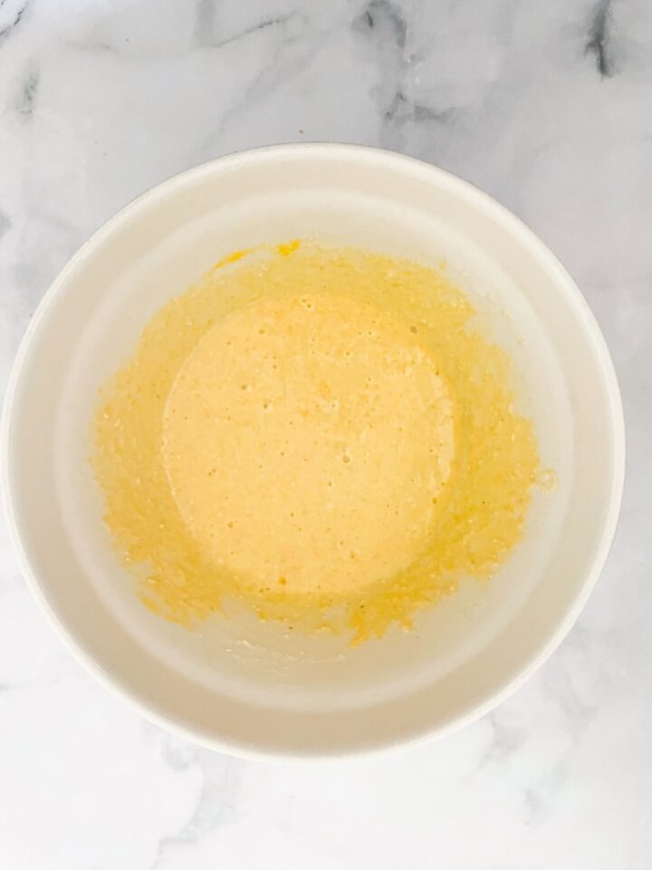 A simple recipe for gluten free cornbread muffins that are as welcome on the Thanksgiving table as they are with a bowl of soup. Wet ingredients for cornbread muffins in a bowl.