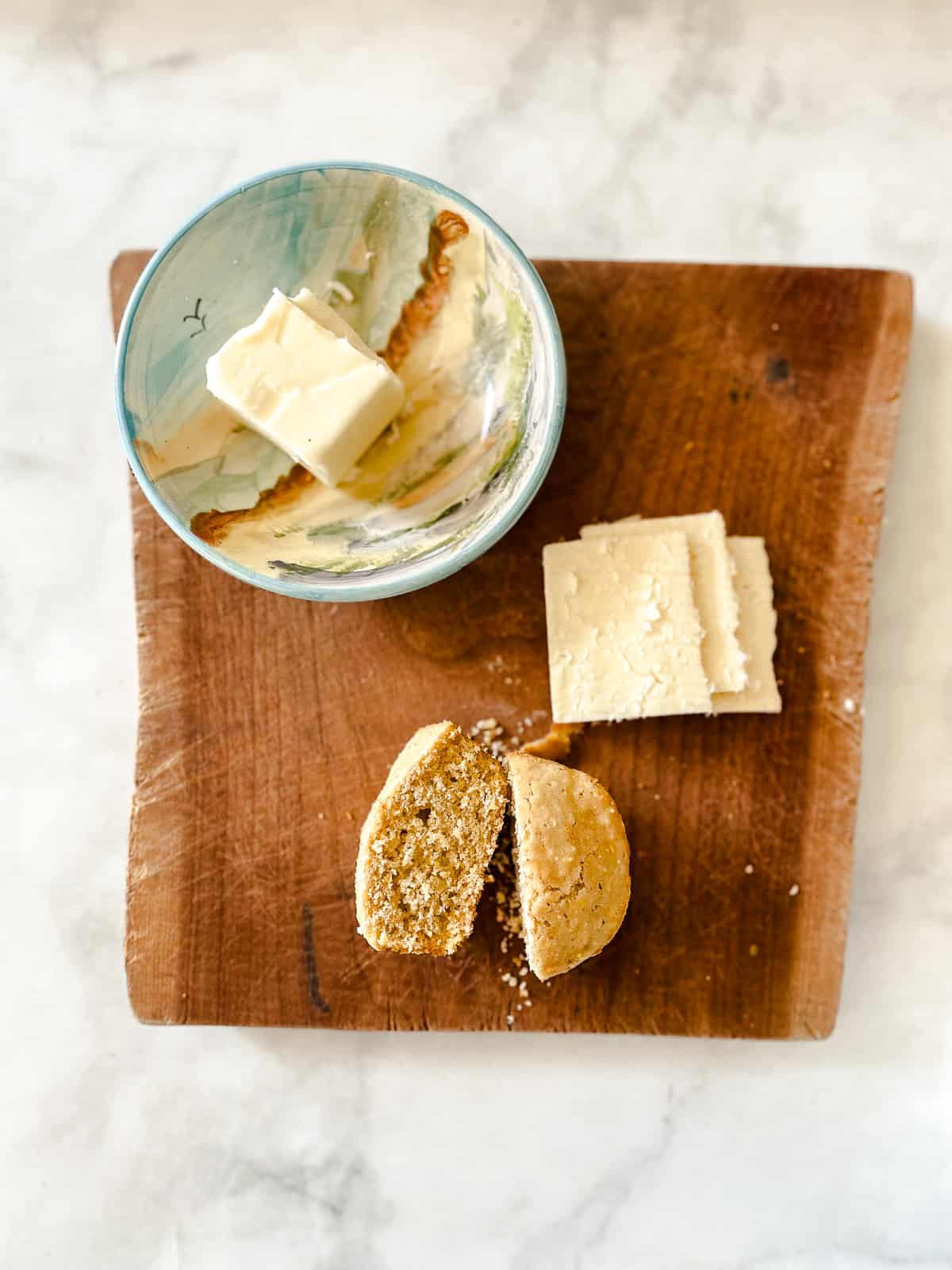 A simple recipe for gluten free cornbread muffins that are as welcome on the Thanksgiving table as they are with a bowl of soup. Cornbread muffins with cheese and butter.