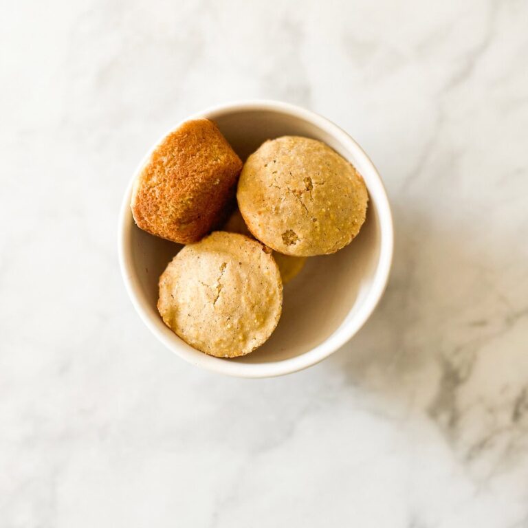 A white bowl of gluten free cornbread muffins.