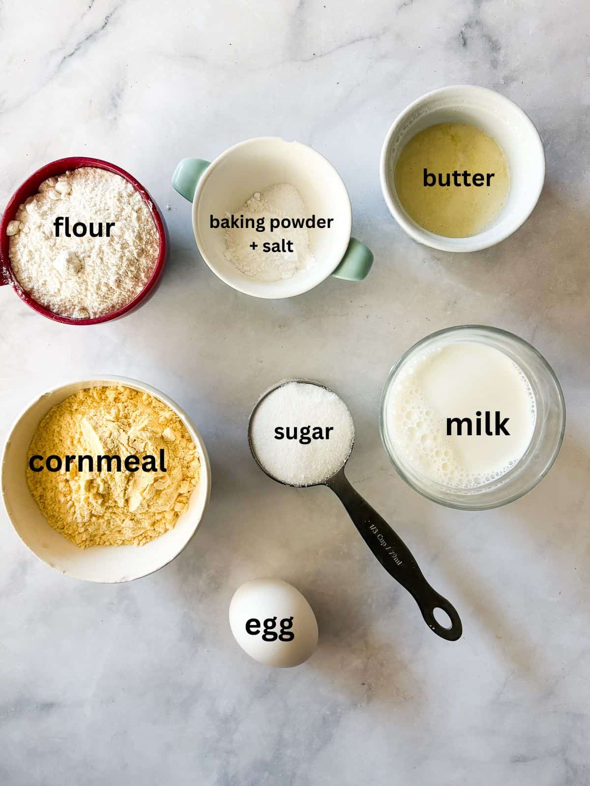 A delicious, lightly sweet homemade cornbread recipe that's made in 1 bowl. Perfect with your favorite soup, stew or chili. Ingredients for homemade cornbread are text-labeled.