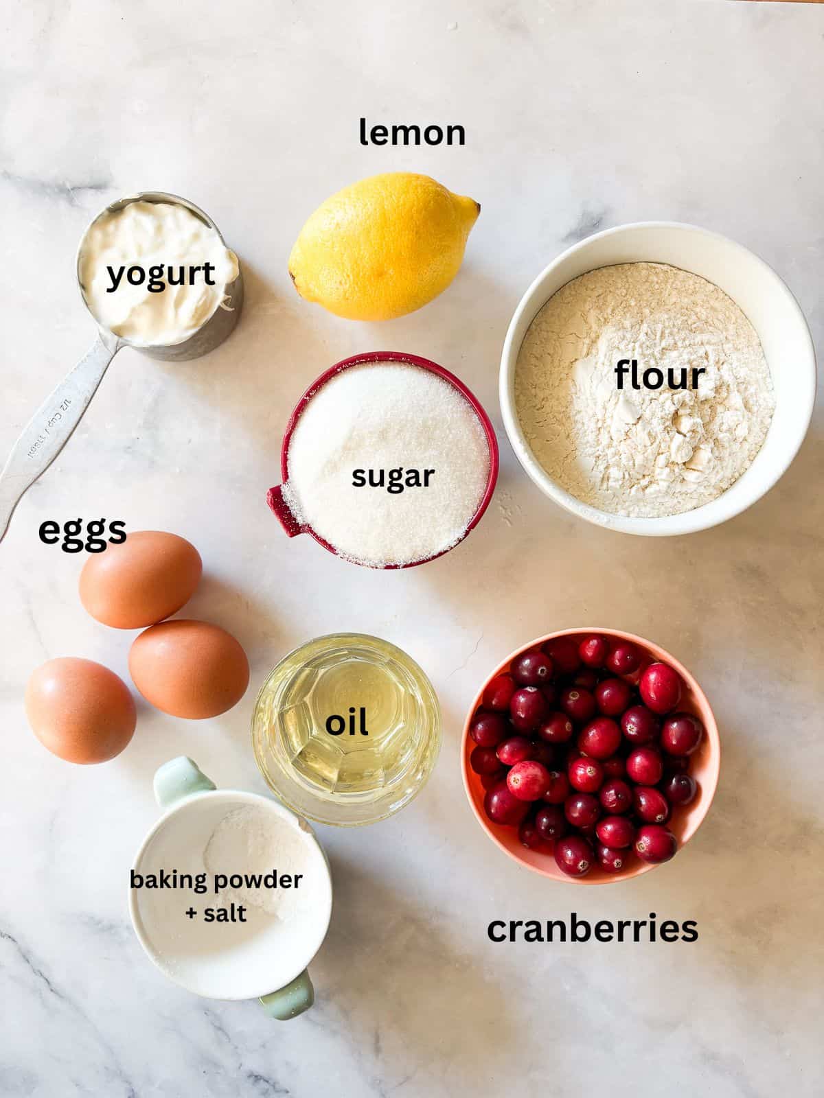 This gorgeous lemon cranberry bread features a lemon-scented loaf swirled with juicy cranberries. Perfect for holiday baking. Ingredients for lemon cranberry bread are text-labeled.