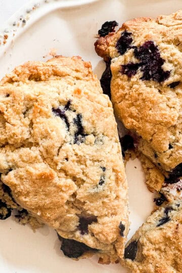 A few blueberry lemon scones on a plate.