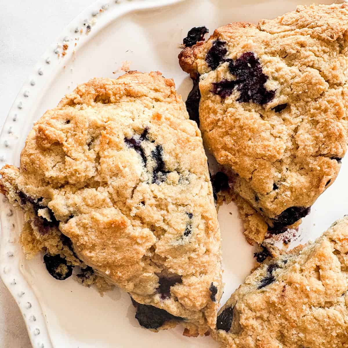 A few blueberry lemon scones on a plate.