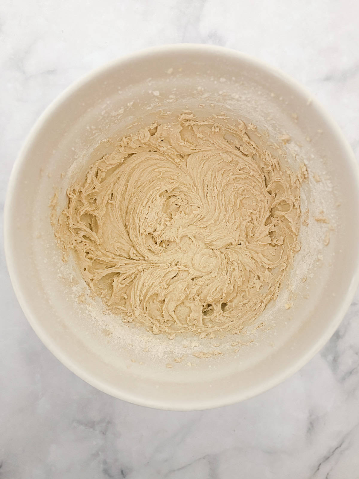 Studded with juicy berries, this sweet and soft cranberry cake is a lovely holiday bake. Great with brunch, or as dessert with ice cream. The batter minus cranberries for cranberry cake in a bowl.