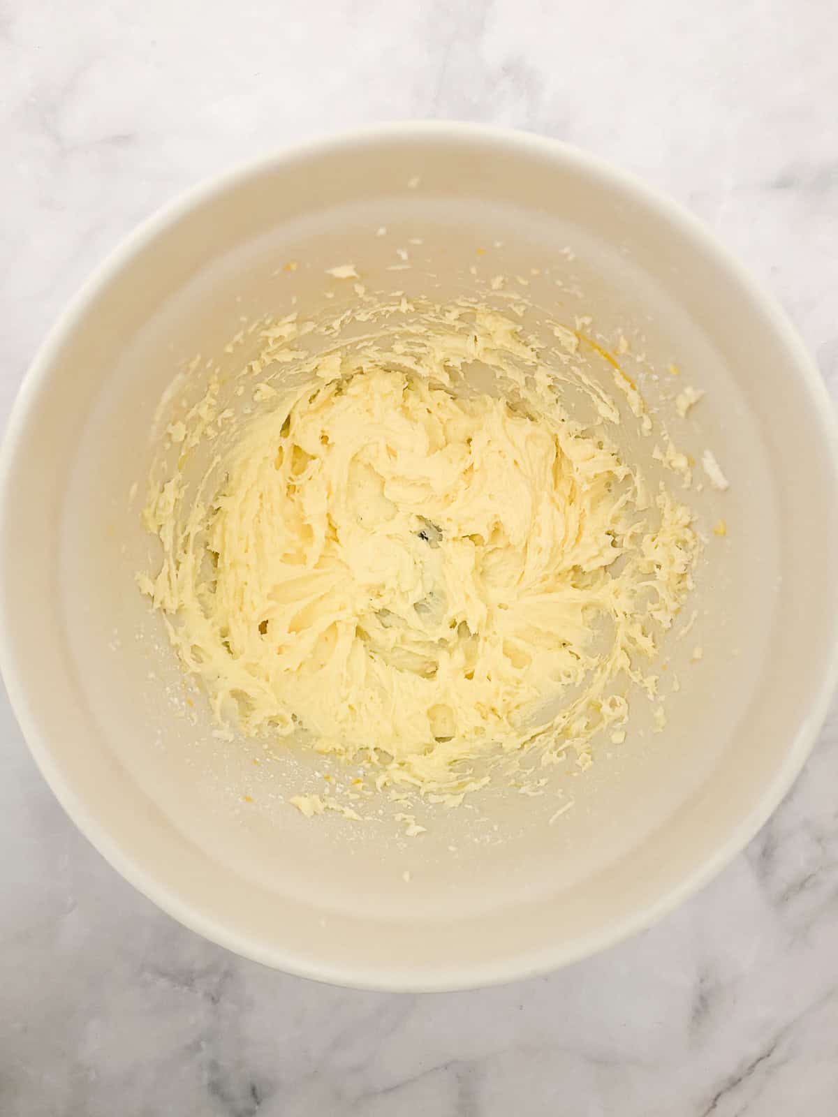 Studded with juicy berries, this sweet and soft cranberry cake is a lovely holiday bake. Great with brunch, or as dessert with ice cream. Butter and sugar creamed in a bowl for cranberry cake.