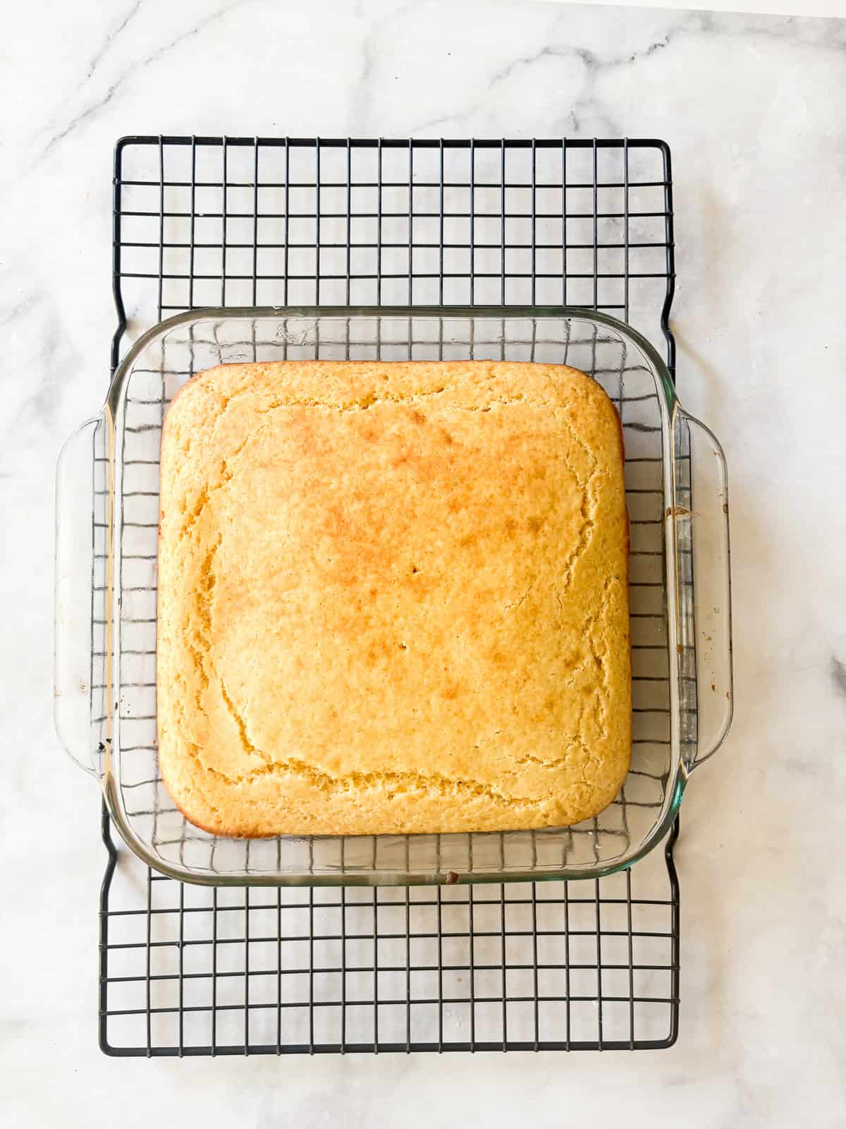 A delicious, lightly sweet homemade cornbread recipe that's made in 1 bowl. Perfect with your favorite soup, stew or chili. A pan of homemade cornbread cools on a rack.