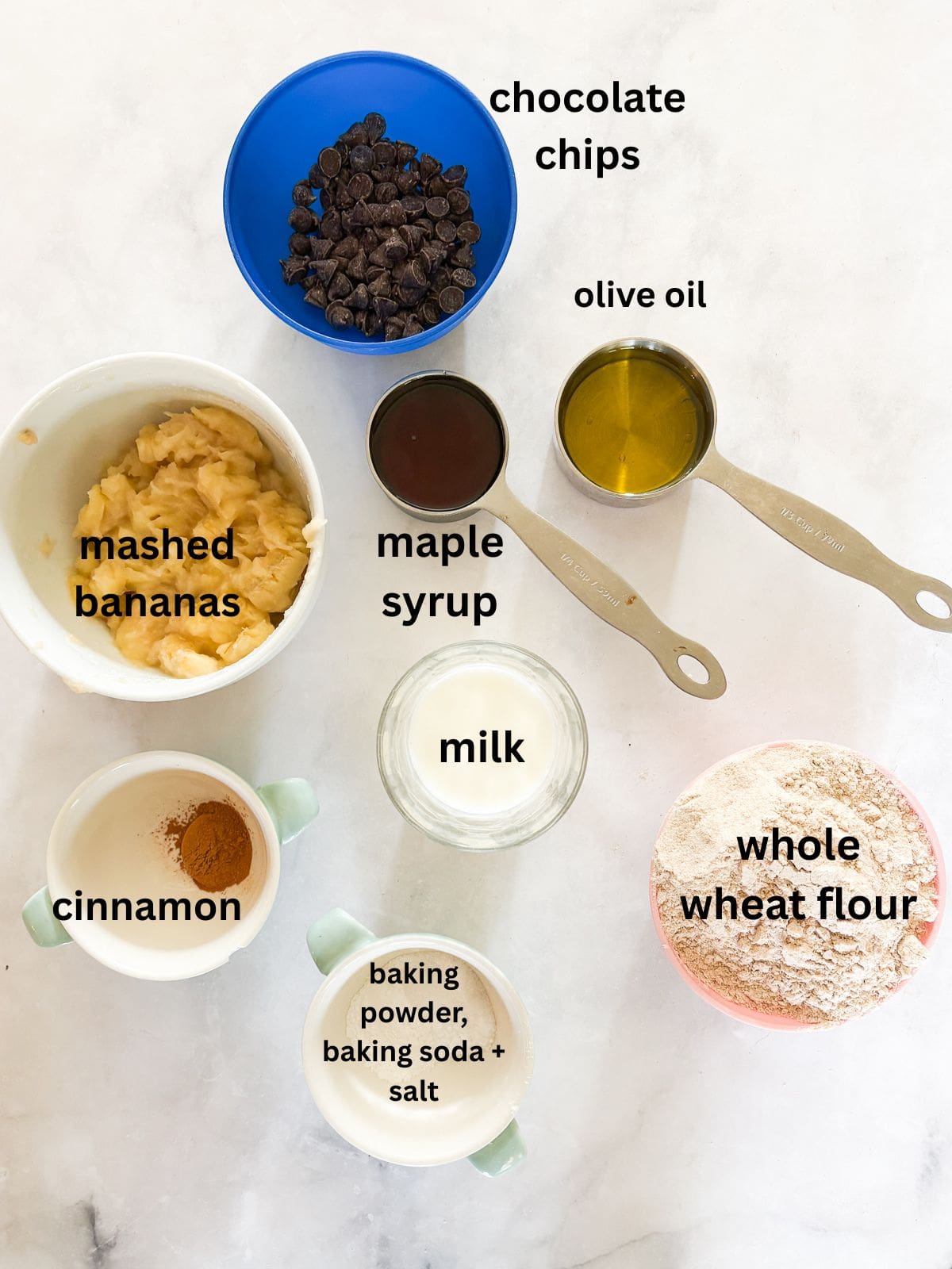 These perfect bite-sized mini banana muffins are made with whole-grain flour, maple syrup, and heart-healthy olive oil. Ingredients for mini banana muffins are text-labeled.