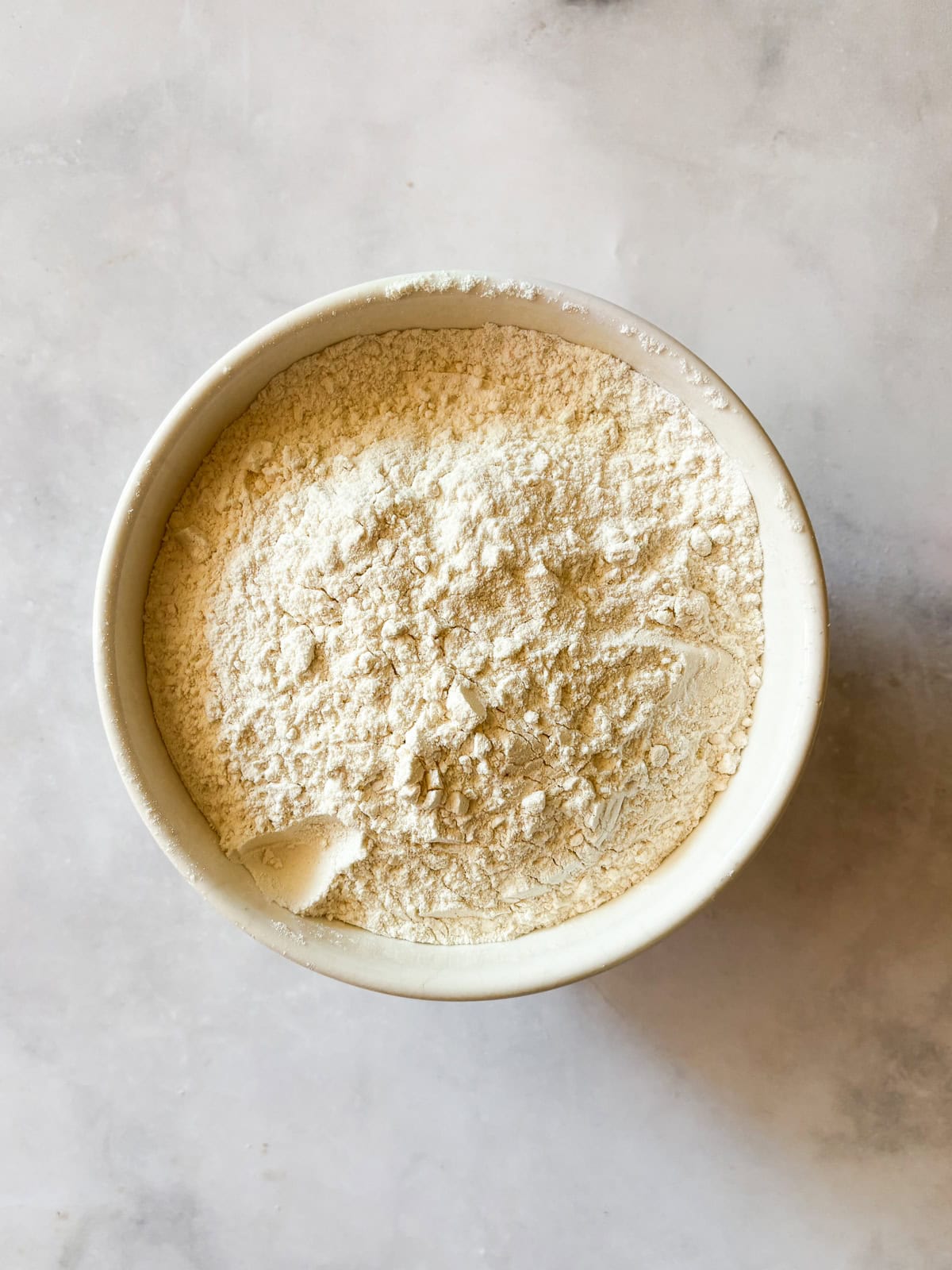 This buttery chocolate chip cookie cake is made with whole wheat flour and brown sugar for a touch of caramel sweetness. Flour whisked with baking soda and salt for chocolate chip cookie cake.