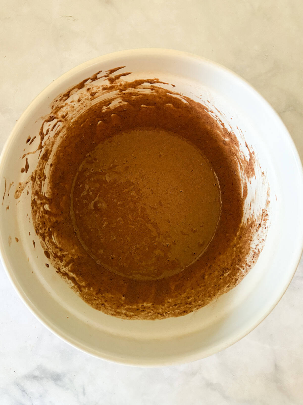 Tender, chocolatey vegan chocolate cupcakes frosted with a sumptuous vegan chocolate buttercream are out-of-this-world good! The combined batter for vegan chocolate cupcakes in a bowl.